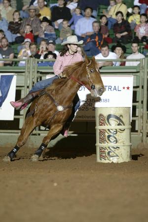 Primary view of object titled '[Woman Barrel Racing at Cowtown Coliseum]'.