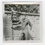 Photograph: [Lowell Flamm Holding a Combat Infantry Company Pennant]