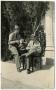 Primary view of Two Men Sitting Outside, Reading Letters, (1937?)