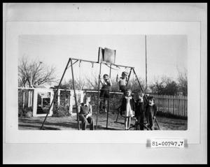 Primary view of object titled 'Children on Swingset in Backyard'.