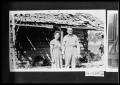 Photograph: Man and Woman by Log Cabin