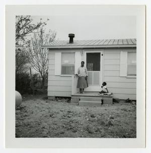Primary view of object titled '[Woman and Child Outside a House]'.
