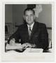 Photograph: [Photograph of Wilfred Moore Seated at Desk]
