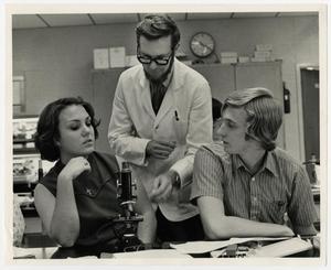 Primary view of object titled '[Photograph of Dr. Ben Pilcher With Two Students]'.