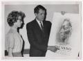 Photograph: [Photograph of Man and Woman Looking at Picasso Poster]