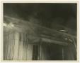 Photograph: [Photograph of a Fireman on a Roof]