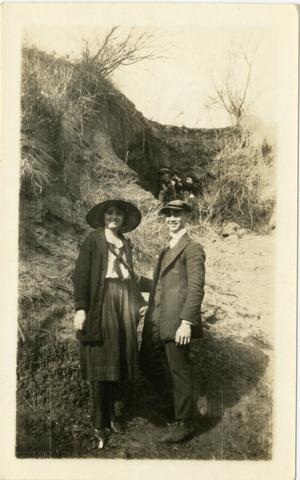 Primary view of object titled '[Photograph of Ernest Witt and a Woman at Base of Hill]'.