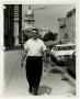 Photograph: [Photograph of Man Walking on Sidewalk]
