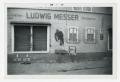 Photograph: [Photograph of German Store and Werewolf Sign]