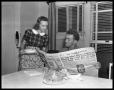 Photograph: [Man and Woman Reading Newspaper]