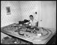 Photograph: Young Man with Model Train Setup