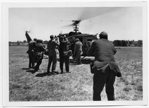 Primary view of object titled '[Cameramen Outside of a Helicopter as Someone Exits]'.
