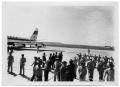 Photograph: [People on a Runway Near an Airplane]