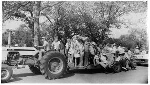 Primary view of object titled '[Children and Adults Being Pulled on a Trailer]'.