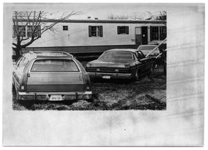 Primary view of object titled '[Cars Parked Outside a Trailer]'.