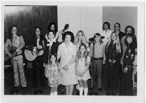 Primary view of object titled '[Lady Bird Johnson Standing with the Threadgill Family Band]'.