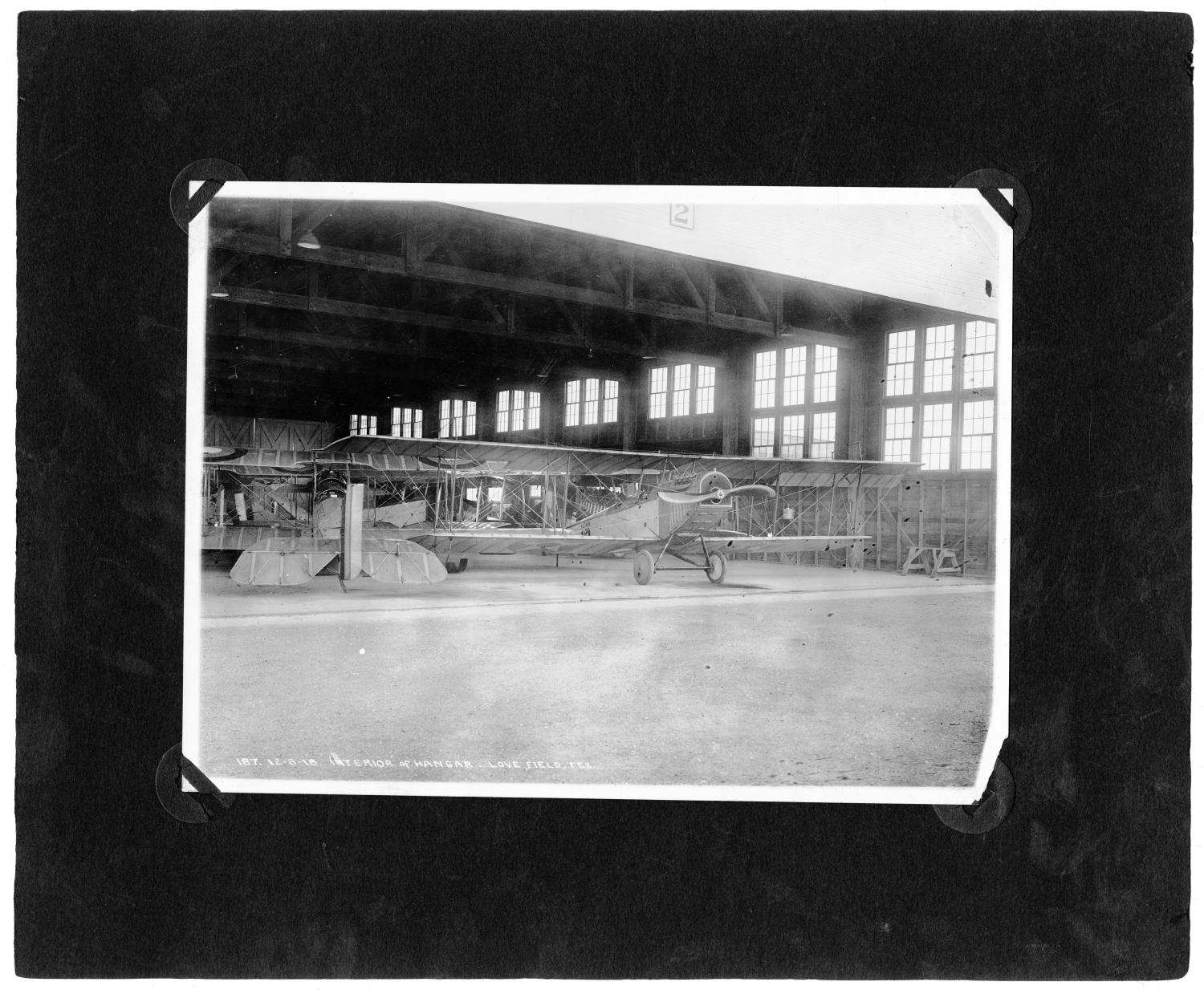 [Biplane and Interior of Hangar]
                                                
                                                    [Sequence #]: 1 of 1
                                                