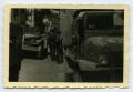 Photograph: [Photograph of Soldiers and Trucks in Street]