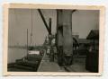 Photograph: [Soldiers Standing on the Port Next to a Barge]