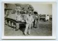 Photograph: [Four Soldiers Stand by an Armored Vehicle]