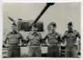Photograph: [Four Soldiers Standing in Front of a Tank]