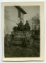 Photograph: [Four Soldiers Sitting in a Tank]