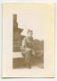 Photograph: [A Soldier Sitting at the Base of a Monument]