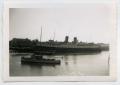 Photograph: [Photograph of a Large Ship by a Dock]