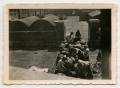 Photograph: [Soldiers Digging Through Bundles of Items]
