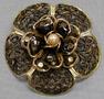 Primary view of [Black lace floral pin with gold trim and pearl in center]