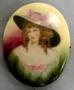 Physical Object: [Ceramic pin, color portrait of vistorian lady on front]