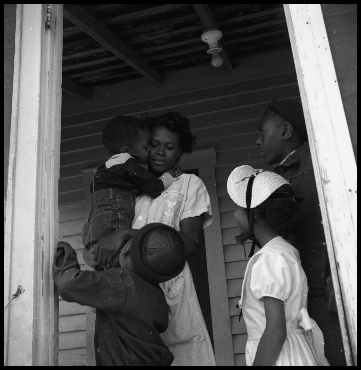 [Children Standing with a Woman in a Doorway]
                                                
                                                    [Sequence #]: 1 of 1
                                                