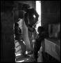 Photograph: [Children with a Cowboy in a Doorway]