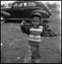 Photograph: [Young Boy in front of a Car]