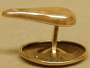 Primary view of object titled '[One of a pair of copper cuff links in the shape of a teardrop]'.