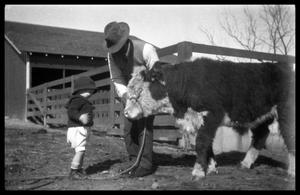 Primary view of object titled '[Man and Toddler with a Calf]'.
