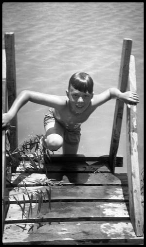 Primary view of object titled '[Boy Climbing Out of Water]'.