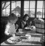 Photograph: [Boy and Girl Eating at a Table]