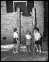 Photograph: [Three Children Standing at Bell]