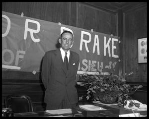 Primary view of object titled '[Mayor Bill Drake standing in front of sign]'.