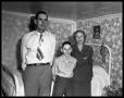 Thumbnail image of item number 1 in: 'Couple and a young boy standing in bedroom'.