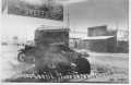 Photograph: [Automobile underneath Palace of Sweets sign]