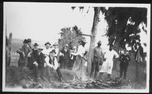 Primary view of object titled '[Group of men near an underground grill pit at Camp George]'.
