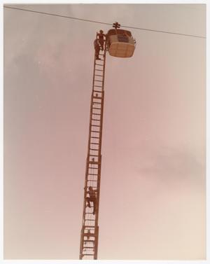 Primary view of object titled '[Firefighters Rescue Sky Tram Rider at the Fair]'.