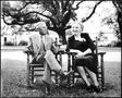 Photograph: [Mrs. And Mrs. Albert Peyton George sitting in wooden rocking chairs]