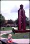 Photograph: [Child Sitting Near Martin Luther Statue]