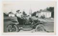 Photograph: [Photograph of a Man in an Old Car]