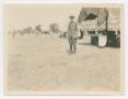 Primary view of [Harry Bickler Stands, Guarding a Truck]