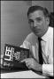 Photograph: [Photograph of Robert Oswald Holding His Book About His Brother, Lee …