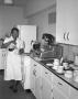 Photograph: [Woman Pouring Coffee in a Kitchen]
